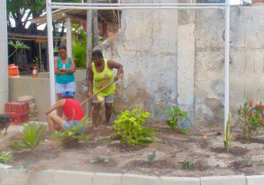 Moradores restaurando o jardim na nova entrada para a Vila Autódromo.
